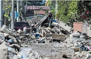  ?? ORLANDO SIERRA AFP VIA GETTY IMAGES ?? People, seen here trying to recover belongings after the recent passage of Hurricane Eta in El Progreso, Honduras, are now bracing for Hurrican Iota, a tropical storm brewing in the Caribbean.