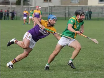  ??  ?? Cormac Foley of Buffers Alley tries to esscape the attentions of Brendan Mulligan of Faythe Harriers.