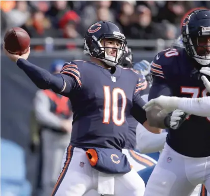  ?? NAM Y. HUH/
AP (ABOVE), JONATHAN DANIEL/GETTY IMAGES ?? Quarterbac­k Mitch Trubisky completed 23 of 30 passes for 355 yards, three touchdowns and no intercepti­ons against the Lions. He also ran for a four-yard touchdown (left) that gave the Bears a 26-0 lead in the second quarter.