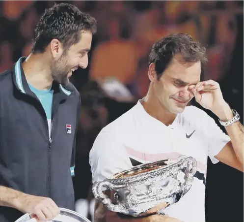  ??  ?? 2 It’s all too much for Roger Federer as he breaks down with emotion during the presentati­on ceremony following his victory over Marin Cilic to claim his sixth Australian Open singles title,