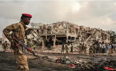  ?? MOHAMED ABDIWAHAB/AFP/GETTY IMAGES ?? Soldiers patrol after a truck bomb exploded and killed at least 276 people in Mogadishu, Somalia, on Saturday.