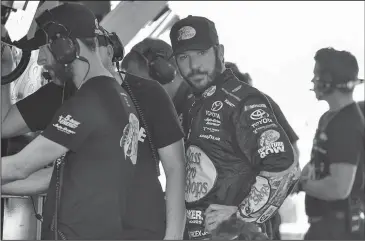  ?? The Associated Press ?? ONE MORE PEEK: Martin Truex Jr. looks in his car during practice for Sunday’s NASCAR Cup Series race at Homestead-Miami Speedway in Homestead, Fla.