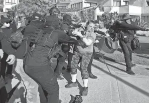  ?? NELVIN C. CEPEDA/SAN DIEGO UNION TRIBUNE/TNS ?? The defendants are accused of using pepper spray, flag poles, sticks and other items to attack a pro-trump crowd Jan. 9 on the streets and boardwalk near Crystal Pier in San Diego.