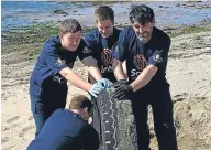  ??  ?? Some of the team with one of the tyres they found.