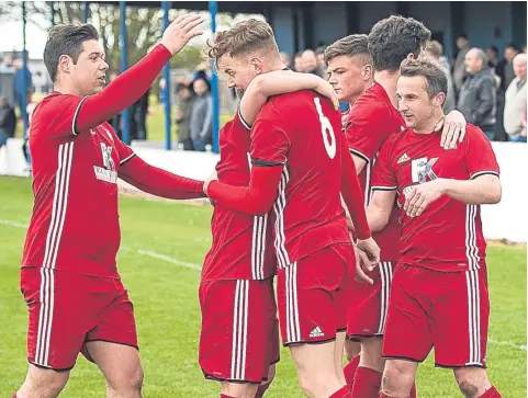  ??  ?? Broughty Athletic’s Stewart McConnachi­e (right) is mobbed by team-mates after opening the scoring against Violet.