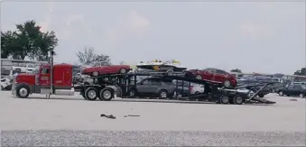  ?? PAT HARRIS ENTERPRISE-LEADER ?? More wrecked vehicles and a boat arrived last week at the Insurance Auto Auctions hilltop, located at the intersecti­on of U.S. 62 and Arkansas 45. A fence is being erected, which will hide the hundreds of damaged vehicles from those traveling this route.