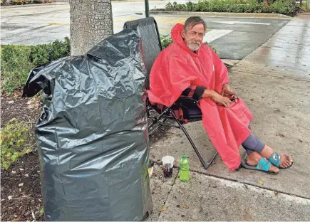  ?? JAMES COLEMAN/PALM BEACH POST ?? West Palm Beach’s Kelly Perkins says he has been homeless for four years and that a sidewalk on Belvedere Road is his permanent home.