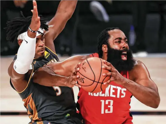  ?? Mike Ehrmann / Getty Images ?? James Harden forces the issue against the Thunder’s Luguentz Dort while thriving early in Game 6 before going 1 of 6 from the field in the fourth quarter.