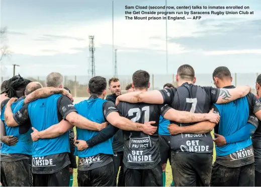  ??  ?? Sam Cload (second row, center) talks to inmates enrolled on the Get Onside program run by Saracens Rugby Union Club at The Mount prison in England. — AFP