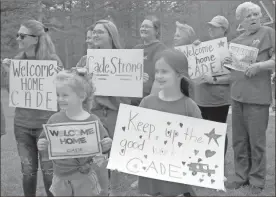  ?? Doug Walker ?? Ava Joy Wright (left), 5, and Abbie Grace Johnson, 7, are among the large group of family and friends who turned out to welcome Cade Tanner home from the Shepherd Center hospital Thursday.