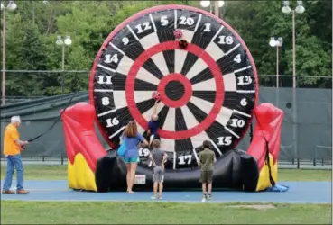  ?? JONATHAN TRESSLER — THE NEWS-HERALD ?? A view of the late afternoon action at one of Mentor CityFest’s newest attraction­s, soccer darts, which involves kicking Velcro-covered soccer balls at a larger-than-life, inflatable target is seen in this Aug. 24 photo.