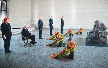  ?? AFP ?? German Chancellor Angela Merkel and other top leaders attend a wreath laying ceremony to mark the 75th anniversar­y of the end of World War II in Berlin.