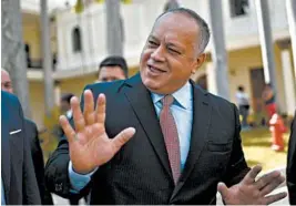  ?? MATIAS DELACROIX/AP ?? Socialist party President Diosdado Cabello jokes with lawmakers at the National Assembly in Caracas, Venezuela. Cabello announced that he has tested positive for COVID-19.