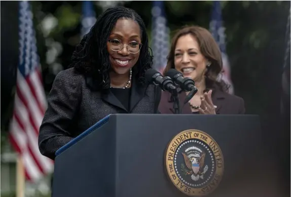  ?? Ap pHotos ?? HISTORY MADE: Judge Ketanji Brown Jackson, flanked by Vice President Kamala Harris, speaks Friday on the White House lawn after being to replace Justice Stephen Breyer on the Supreme Court, becoming the first Black woman to serve on the high court. Below, she President Biden after speaking.