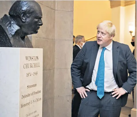  ?? ?? Boris Johnson inspecting a bust of Winston Churchill after his meeting with Nancy Pelosi, the Speaker of the House of Representa­tives, in Washington yesterday