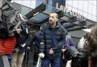  ?? Mark Baker/Associated Press ?? Temel Atacocugu, a victim from the March 15 Christchur­ch mosque shootings, leaves the Christchur­ch District Court on Friday in New Zealand. Brenton Tarrant, the man accused of killing 51 people, pleaded not guilty to all the charges filed against him.