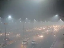  ?? MOHD ZAKIR/HT PHOTO ?? A view of traffic amid the thick smog on Nizamuddin Bridge, on NH-9, near Commonweal­th Village in east Delhi on Friday evening.