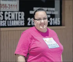  ?? MICHAEL GARD/POST-TRIBUNE ?? Jenn Watts stands in front of her closed storefront in Hebron, The Watts Center for Diverse Learners, on Wednesday. Watts was forced to shut down the location early in the COVID-19 pandemic and continues to run the business from her home.