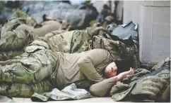  ?? STEFANI reynolds / GETTY IMAGES FILES ?? Members of the National Guard sleep in the U.S. Capitol on Jan. 14 after security was increased in Washington following the breach of the U.S. Capitol the week before.