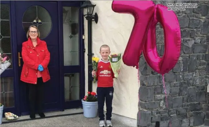  ??  ?? Alex and Harry deliver flowers to Helen Rochford Brennan for her 70th birthday.