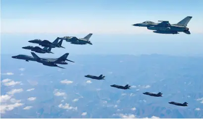  ?? AFP ?? This handout released by the South Korean defence ministry shows a US Air Force B-1B Lancer bomber (L), two US F-35A and two US F-35B stealth jets (far) flying over South Korea with South Korea’s two F-16 (R) and two F-15K (L top) fighter jets during a...