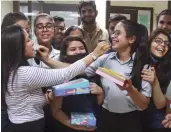  ?? —PTI ?? Students celebrate at a school in Gurgaon on Friday after the CBSE Class 12 exam results were declared.