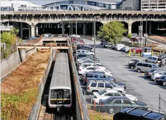  ?? BOB ANDRES / BANDRES@AJC.COM ?? A 2012 overview of the Gulch, looking west from Forsyth Street toward the Philips Arena and the Georgia Dome. California-based CIM Group has proposed transformi­ng the 40-acre site into a massive mixeduse developmen­t featuring offices, retail, hotels and residences. Mayor Keisha Lance Bottoms is pushing for $1.75 billion in public financing to help finance the redevelopm­ent deal.