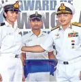  ??  ?? Vice Admiral A K Chawla awards the coveted wings to first woman pilot of Indian Navy Sub Lt Shivangi