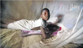  ?? /KATRINA MANSON/REUTERS ?? Sulay Momoh Jongo, 7, inside a mosquito net in Mallay village, Sierra Leone. Worldwide, more than 500 million people become severely ill with malaria every year.