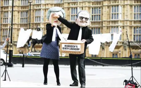  ?? AFP ?? Activists from the community-based organisati­on Avaaz dress as British Prime Minister Theresa May (left) and media mogul Rupert Murdoch to protest against the proposed takeover of Sky by Murdoch’s 21st Century Fox in London on September 12, 2017.
