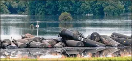  ?? TIM HYNDS / SIOUX CITY JOURNAL ?? Tank cars carrying crude oil derailed about a mile south of Doon, Iowa on Friday morning, possibly due to floodwater­s from the swollen Little Rock River.