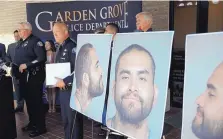  ?? MARCIO JOSE SANCHEZ/ASSOCIATED PRESS ?? Garden Grove Police Chief Tom DaRe, center, and PIO Carl Whitney address the media next to a booking mug shot of Zachary Castaneda posted outside police headquarte­rs in Garden Grove, Calif.