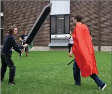  ?? RACHEL DICKERSON/MCDONALD COUNTY PRESS ?? Vincent Russo, left, and Levi Womack try their skill at LARPing on the lawn outside the McDonald County High School library during the library’s Comicon event. LARP stands for Live Action Role Play.