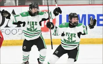  ?? Justin Guido/For the Post-Gazette ?? Pine-Richland’s Colin Campbell, left, and Josh Lanyard celebrate a goal against Peters Township in the PIHL Class 3A Penguin Cup semifinal game March 11. Pine-Richland will go for its fifth title when it plays North Allegheny in the championsh­ip Tuesday.