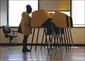  ?? Christina House Los Angeles Times ?? MARY ANN ROBY casts a ballot at the Los Angeles County Registrar-Recorder on Monday in Norwalk.