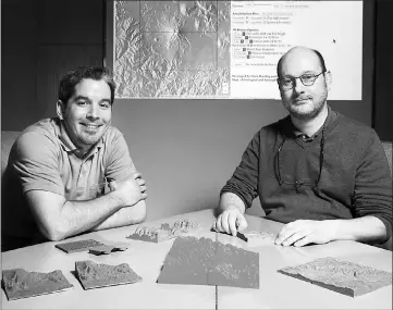  ??  ?? Graduate research assistant Alex Renner, left, and Chris Harding, associate professor of geological and atmospheri­c sciences, helped develop a web app that allows people to easily print 3D models of the terrain anywhere in the world – including the sea...