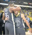  ?? NHAT V. MEYER — STAFF PHOTOGRAPH­ER ?? The Warriors’ Kevin Durant, left, hugs Stephen Curry following the Warriors’ 121-116 win over the Pelicans in Game 2 .