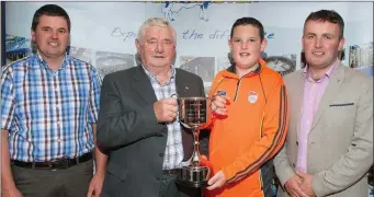  ?? Photo by Ann McNamee ?? Vincent & Shane O’Connell accepting on behalf of Donal the Dairymaste­r Perpetual cup for overall champion cow at the Kerry Holstein Frieisan Breeders club herds competitio­n. (l-r) Club President Maurice Harty, Vincent & Shane O’Connell and Pat Ryan...