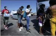  ?? ERIC GAY, FILE - THE ASSOCIATED PRESS ?? In this Sept. 20 photo, migrants, many from Haiti, board a bus after they were processed and released after spending time at a makeshift camp near the Internatio­nal Bridge in Del Rio, Texas. President Joe Biden embraced major progressiv­e policy goals on immigratio­n after he won the Democratic nomination, and he has begun enacting some. But his administra­tion has been forced to confront unusually high numbers of migrants trying to enter the country along the U.S.-Mexico border and the federal response has inflamed both critics and allies.