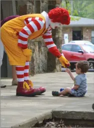  ?? SUBMITTED PHOTOS ?? Ronald McDonald hands a rubber ball to a little boy during a meet-and-greet during last year’s SpringFest in Heber Springs. Ronald is scheduled to appear again on Saturday.