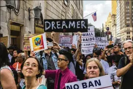  ?? HIROKO MASUIKE / THE NEW YORK TIMES ?? People protesting the Trump administra­tion’s plans to cancel the DACA program march on Trump Tower in New York in August. The program shields some 700,000 young, undocument­ed immigrants from deportatio­n.