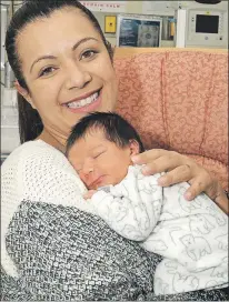  ?? JOE GIBBONS/THE TELEGRAM ?? Lindoura O'Neill of Bay Bulls cradles her three-day old son Antonio at the Janeway Hospital newborn obstetrics unit Monday afternoon. She and hubby Cortney O'Neill are in full support of the Eastern Health's "What? No Bath for the first 24 hrs? It's...