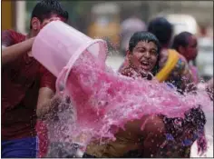  ?? (AP/Mahesh Kumar A.) ?? Children play with colored water Tuesday as they celebrate Holi in Hyderabad, India.