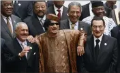  ?? AMR NABIL — THE ASSOCIATED PRESS FILE ?? Libyan leader Moammar Gadhafi, center, with Egyptian President Hosni Mubarak, right, and his Yemeni counterpar­t Ali Abdullah Saleh, left, pose during a group picture with Arab and African leaders during the second Afro-Arab summit in Sirte, Libya, on Oct. 10, 2010.