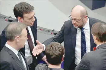  ?? — AFP ?? Martin Schulz (top R), leader of social democratic SPD party, speaks to party colleagues Nils Schmid (top L), Thomas Oppermann (bottom L) and Karl Lauterbach (R) on the sidelines of a memorial ceremony for late parliament speaker Philipp Jenninger on...