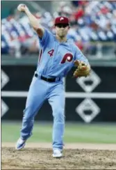  ?? TOM MIHALEK — THE ASSOCIATED PRESS ?? Phillies infielder Scott Kingery throws a pitch during the eighth inning against the Mets on Thursday in the first game of a doublehead­er. The Mets won, 24-4.