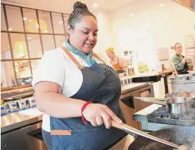  ?? Photos by Elizabeth Conley/Staff photograph­er ?? Evelyn Garcia sautés carrots in the kitchen at Jūn, her new restaurant concept described as “new Asian American.”