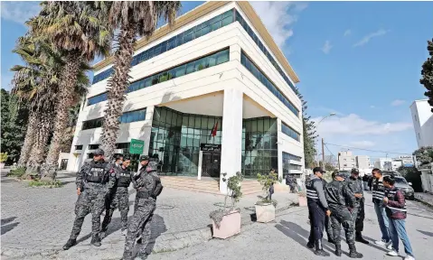  ?? | EPA ?? MEMBERS of the Tunisian security forces outside the closed headquarte­rs of Tunisia’s Supreme Judicial Council in Tunis. Tunisian President Kais Saied has announced the dissolutio­n of the Superior Council of the Judiciary, an independen­t body responsibl­e for appointing judges, accusing it of being biased.