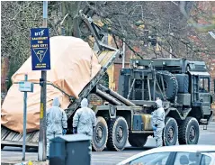  ??  ?? Specialist­s from the RAF and Marines remove a police car and ambulance from Salisbury for testing, left and bottom