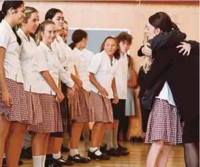  ??  ?? New Zealand Prime Minister Jacinda Ardern embracing a student during her visit to Cashmere High School in Christchur­ch yesterday.